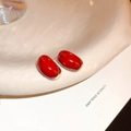 Elegant red enamel oval stud earrings with golden metal base on a white ceramic plate - Red Oval Bean Stud Earrings (12# Silver Earring Post)