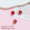 Close-up of a 9x12mm mini red enamel apple pendant with gold plating for DIY jewelry making - Small Apple