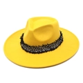 Detail of yellow wool fedora featuring a textured black and white tassel band - Yellow