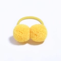 Close-up of bright yellow double fluffy pompom hair ties on a plain white background - Yellow
