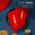Individual red festive wet wipe packet with golden text on black tray with red fan - All the Best Red Style / Red