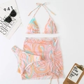 Detailed macro view of three-piece printed bikini set with drawstring beach skirt - S / Pink Swirl Print