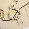 Pastel ceramic beaded bracelet with star and bone charms on traditional calligraphy fan - Star (340A)