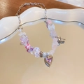 Detail of sweet beaded necklace featuring pink heart zircon pendant and metal bow charm - Pink Heart Necklace