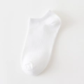 Minimalist white low-cut ankle socks with ribbed cuffs and soft cotton knit texture - White