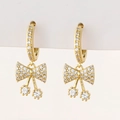 Close-up of golden bow earrings with micro-pave zircons and round crystal drops - Q-Bow