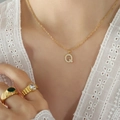 Gold plated titanium steel necklace with crystal pavé letter Q pendant worn by model - Letter Q / Gold