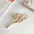 Detailed close-up of a floral metal hair claw with pink enamel flowers and pearls - Purple Lily Claw Clip