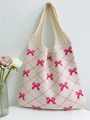 Knitted tote bag in cream with vibrant pink bow patterns and a textured finish - Apricot and Rose Red