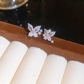 Macro shot of silver butterfly stud earrings with sparkling cubic zirconia on brown velvet - 925 Silver Pin (Real Gold Plating) / Silver