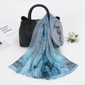 Lightweight floral chiffon scarf in blue and gray draped over a black textured handbag - 150cm / Light Blue