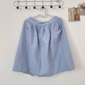Close-up of light blue cotton apron with dual large front pockets and elastic waist - Light Blue