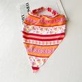 Detailed close-up of floral satin headwrap with pink and orange patterns and elastic band - Satin Red Orange Floral