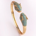 Detailed view of luxury gold-plated leopard head bangle with blue and green crystals - Leopard Head