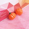 Macro detail of glossy orange resin pumpkin charms with silver metal ring and green stem - with Hook / Pumpkin