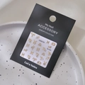 Detailed macro shot of gold constellation nail charms with rhinestones on a display card - MJ-069 Rhinestone Style Gold Stamping / Gold
