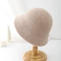 Close-up of beige crochet bucket hat showing fine knit texture and elegant curved brim - Khaki