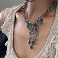 Silver butterfly necklace with abalone shell wings and green gemstone tassels on model - Heavy American Tassel Butterfly Necklace