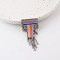 Macro detail of T-shaped brooch with rainbow embroidery and sparkling rhinestone fringe - Letter T