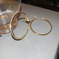Macro view of gold round earrings featuring sparkling crystals on a textured gray gift box - Clip-on Style / 5cm / Gold