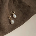 Macro detail of Baroque pearl earrings with sparkling gold pave diamond hooks - Style 6 - Copper Ear Hook