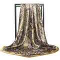 Luxurious golden paisley silk square scarf with satin finish hanging on a display - Golden Paisley