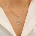 Polished silver leaf pendant necklace worn by a model on a minimalist white background - Branch Leaf Necklace (Stainless Steel)