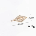 Detail showing a gold metal hair clip with rhinestones, size 5.3cm x 2.2cm, weighing 6.5g - Diamond