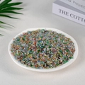 Mix of colorful natural crystal stones and fluorite chips displayed in a white plate - 100 Grams Of Artificial Cat's Eye Stone (3-5mm)