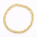 Close-up of gold beaded bracelet with starburst engraved oval charms on white background - Engraved Gold Beads