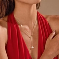 Elegant gold Y-shaped necklace with white freshwater pearls worn by model on red dress - Freshwater Pearl Style 3