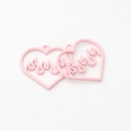 Close-up of pink heart pendants with flame pattern for DIY jewelry making accessories - Pink