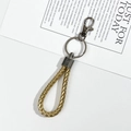 Golden braided leather cord keychain with dark gray metal lobster clasp and ring - Gold