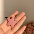 Pink star-shaped hair clip with glossy finish and secure black metal base clamp - Pink Star
