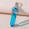 Teal hexagonal crystal pendant with silver metal bail on a textured background - Lake Blue Crystal
