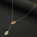 Golden Y-shaped sweater necklace with hollow leaf pendants on black textured surface - Leaves Gold