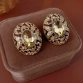 Close-up of vintage gold leaf earrings with champagne stones in a brown velvet box - Gold (Silver Earring Post)