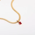 Macro shot of gold snake chain featuring a geometric square red zircon pendant - 40+5cm / Garnet Red