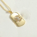 Detail of gold evil eye pendant with white zircon stones and rectangular frame - Rectangle