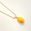Golden snake chain necklace featuring a polished yellow oval pear drop pendant charm - Yellow