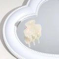 Detailed view of mini iridescent white acetate hair claw clip on heart mirror - Beige