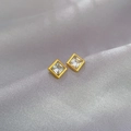 Macro shot of square zircon stud earrings with gold frames on a soft satin background - Square Zirconia (Q115 Gold) / Gold