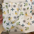 Detail of floral printed canvas tote bag showing the lemon yellow and mint green flower pattern - T-11 White Background with Green Leaves and Green Yellow Small Flowers