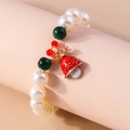Close-up of Christmas beaded bracelet with red bell elk charm and festive pearls - White/Green/Red Beads-Deer Antler Bell