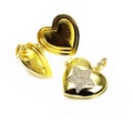 Macro view of gold heart locket pendant with star diamonds in open and closed states - Star Style