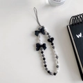 Minimalist beaded phone strap with black bows, heart pendant and white pearls - Black Striped Bow