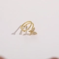 Detailed close-up of double-layered butterfly ring with sparkling zircon in gold finish - Gold