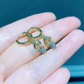 Goldene Astronauten-Ohrringe mit blauen und champagnerfarbenen Zirkoniasteinen im Design - Astronaut