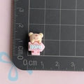 Detailed macro view of a 1.5cm resin miniature bear home sign charm for DIY crafts - Beige Bear with HOME Sign / Mini Small
