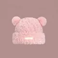 Detail of pink plush knit hat with bear ears and decorative rectangular patch - Pink